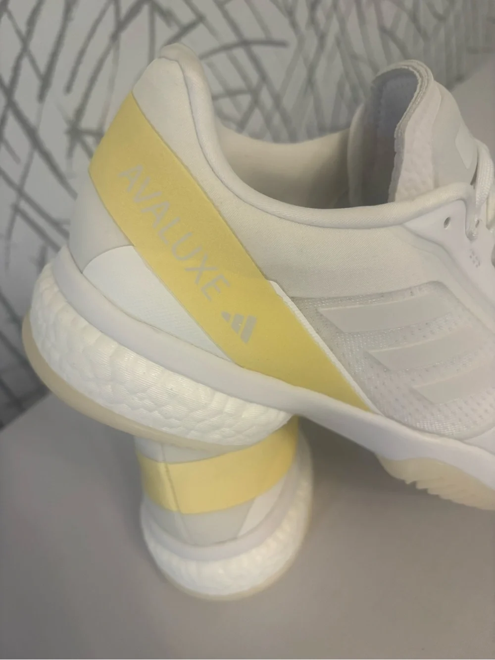 adidas Avaluxe tennis shoes in white with subtle pastel yellow accents. JQ7080